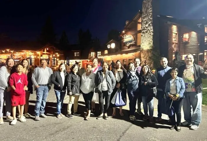 The team gathered for a group photo in the evening outside the lodge
